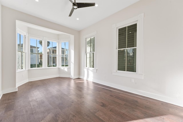 unfurnished room with recessed lighting, dark wood-style flooring, ceiling fan, and baseboards