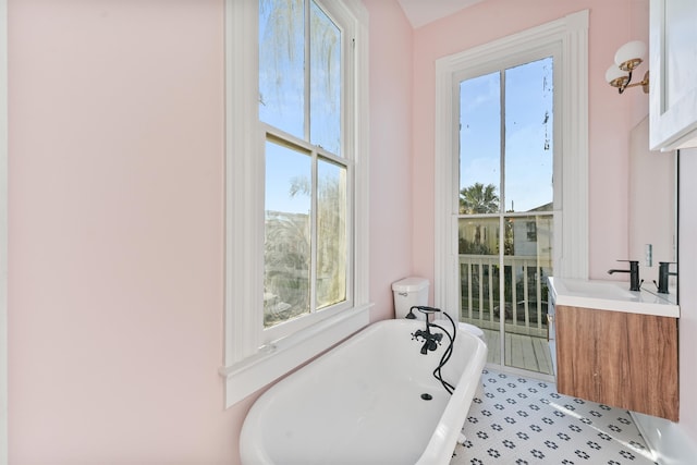 bathroom featuring a washtub and vanity