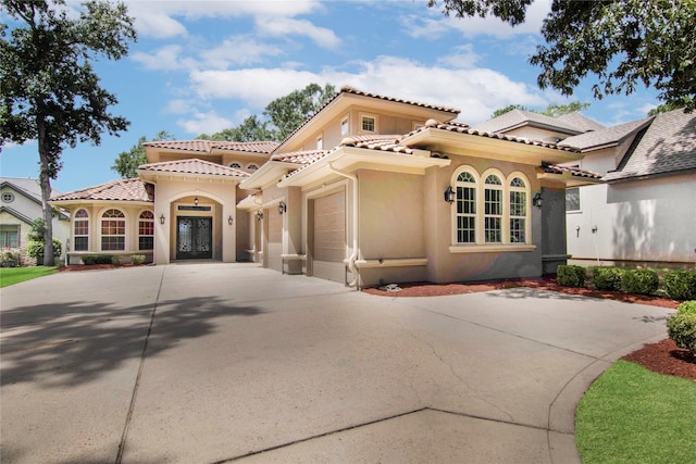 mediterranean / spanish home featuring a garage