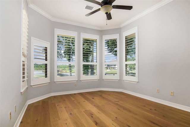 unfurnished room featuring ceiling fan, light hardwood / wood-style floors, and ornamental molding