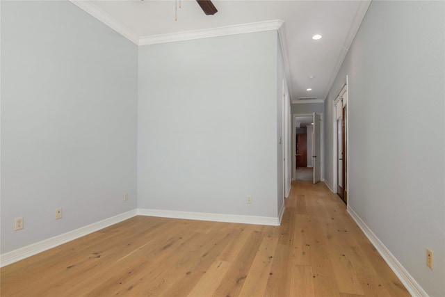 spare room with ornamental molding, ceiling fan, and light wood-type flooring