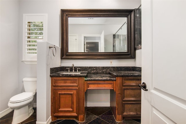 bathroom featuring tile patterned flooring, vanity, and toilet