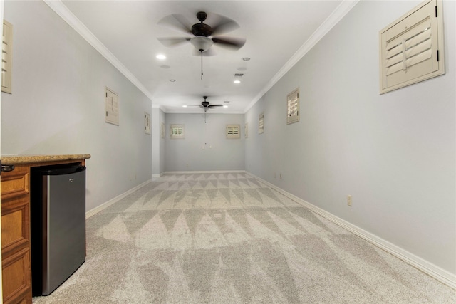 unfurnished living room with light colored carpet, ceiling fan, and crown molding