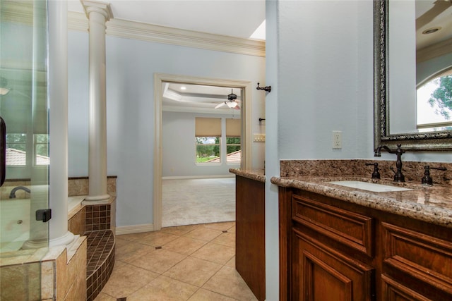 bathroom with crown molding, tile patterned flooring, decorative columns, and tiled tub