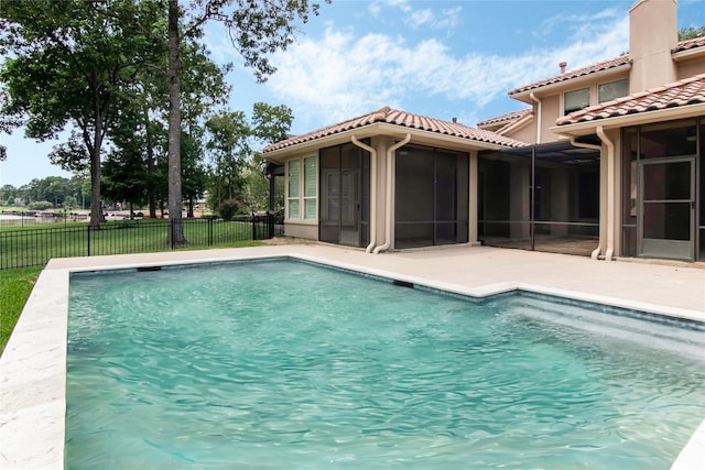 view of pool with a patio area and a sunroom