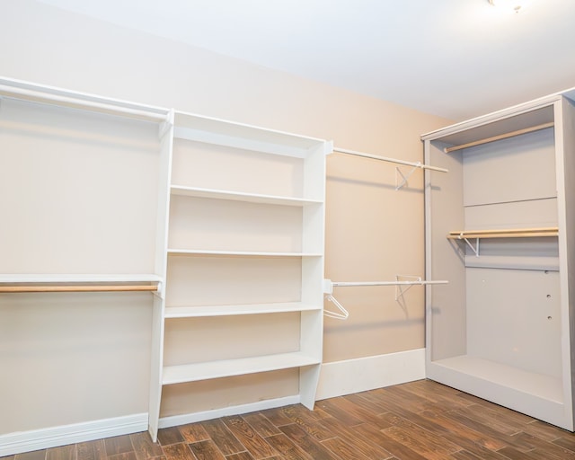 walk in closet with dark hardwood / wood-style floors