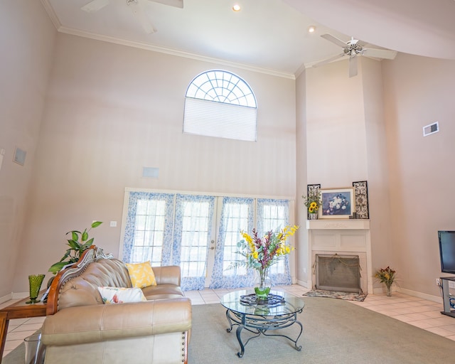 living room with light tile patterned flooring, a high ceiling, and ceiling fan