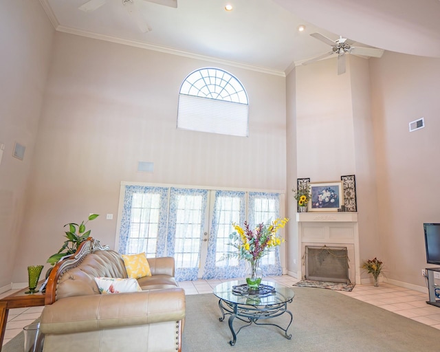living area featuring a high ceiling, tile patterned floors, and ceiling fan