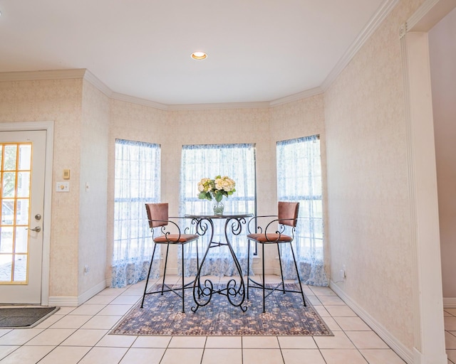 dining room with baseboards, a healthy amount of sunlight, tile patterned floors, and crown molding