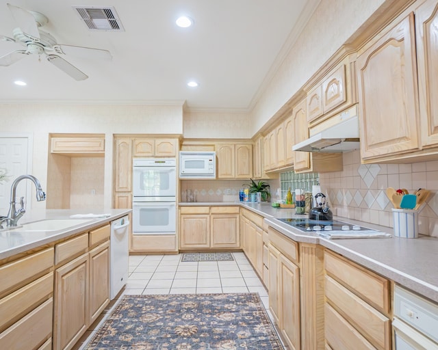 kitchen with light brown cabinetry, decorative backsplash, white appliances, and light tile patterned floors