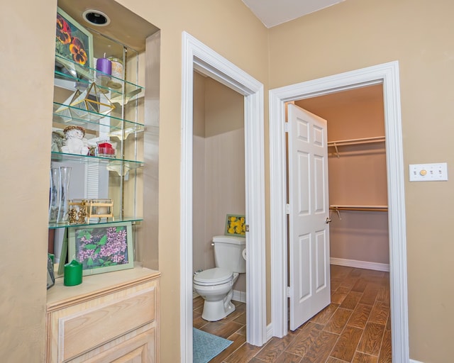 bathroom with hardwood / wood-style flooring and toilet