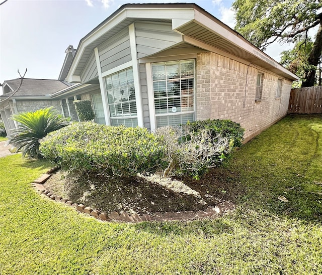 view of side of property with a lawn