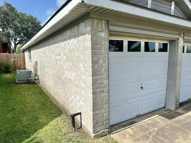 exterior space with a garage and a lawn