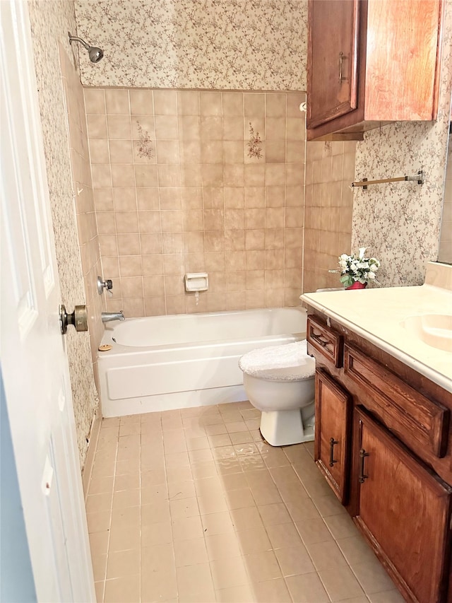 full bathroom featuring tiled shower / bath combo, vanity, and tile patterned flooring