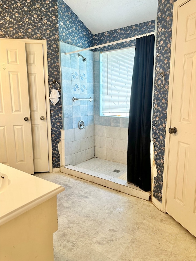 bathroom with tile patterned floors and walk in shower