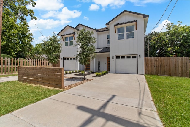 view of front of property featuring a garage and a front yard