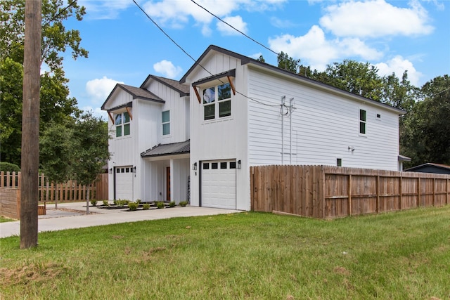 view of front of house featuring a garage and a front lawn