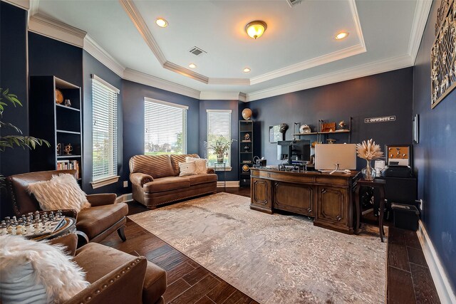 home office featuring hardwood / wood-style floors, a tray ceiling, and ornamental molding