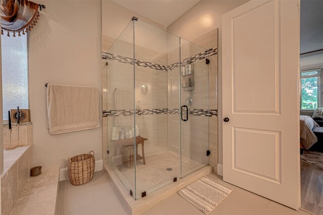 bathroom featuring an enclosed shower and tile patterned floors