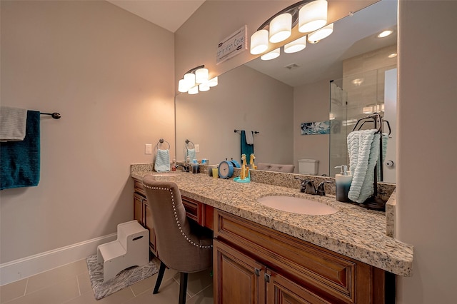 bathroom with an enclosed shower, vanity, tile patterned floors, and toilet