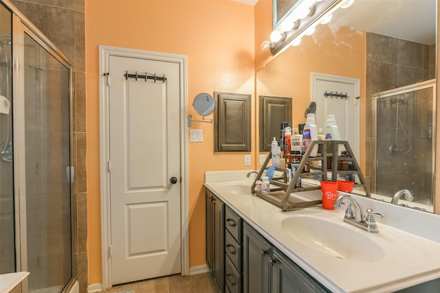 bathroom featuring tile patterned flooring, vanity, and an enclosed shower