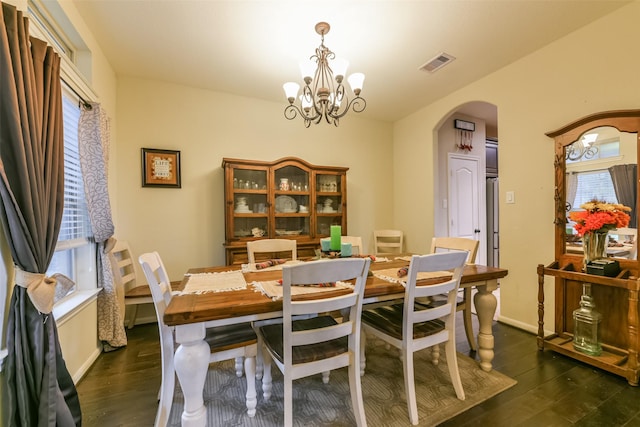 dining room with a chandelier and dark hardwood / wood-style floors