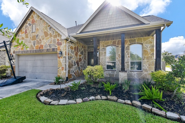 view of front of home with a garage and a front lawn