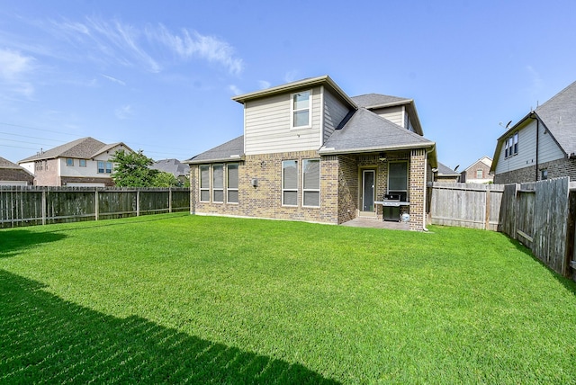 rear view of house featuring a yard