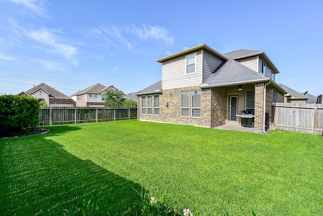 back of house with a lawn and a patio