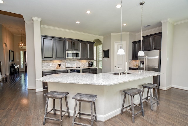 kitchen featuring a large island, sink, hanging light fixtures, and appliances with stainless steel finishes