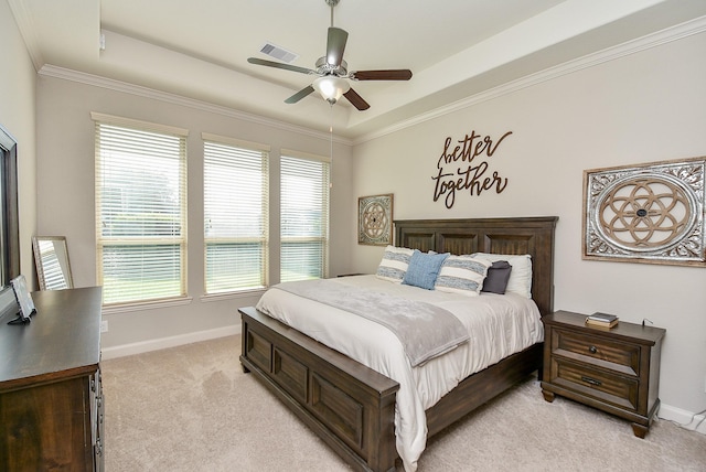 carpeted bedroom with a raised ceiling, ceiling fan, and crown molding