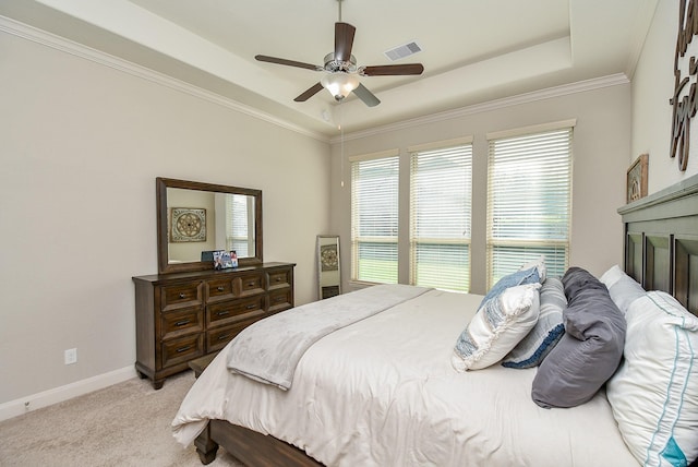 bedroom with ceiling fan, a raised ceiling, light colored carpet, and ornamental molding