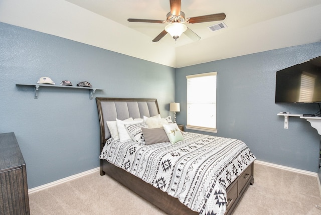 bedroom featuring ceiling fan, light carpet, and vaulted ceiling