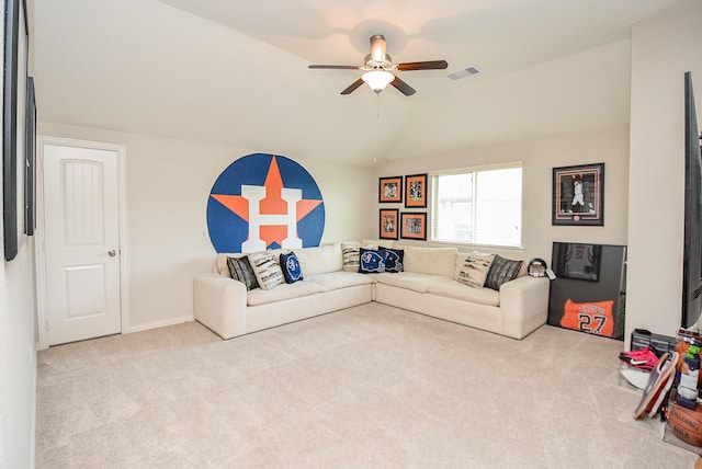 carpeted living room with ceiling fan and lofted ceiling