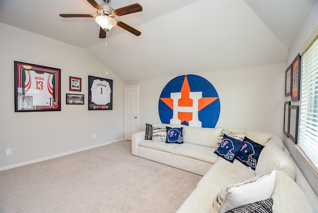 carpeted living room featuring plenty of natural light, ceiling fan, and lofted ceiling