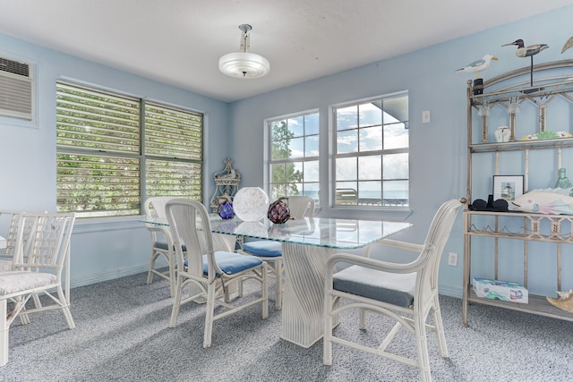 carpeted dining space with a wall mounted AC