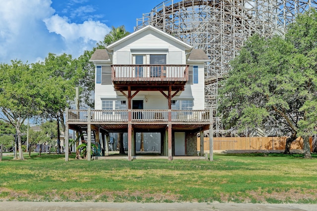 back of property with a deck and a lawn