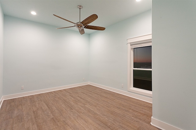 spare room with wood-type flooring and ceiling fan