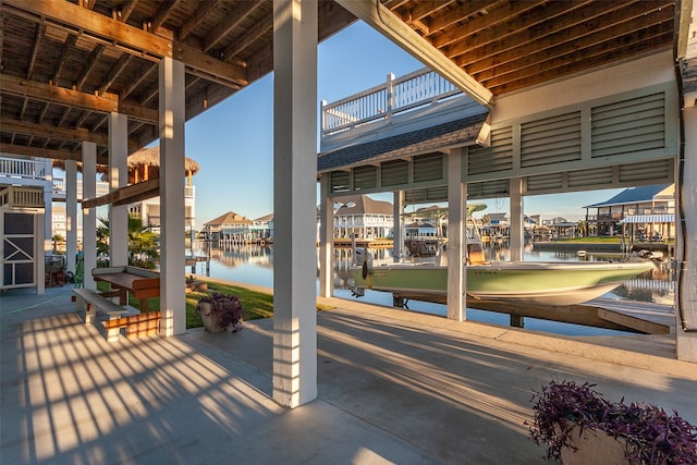 view of patio / terrace with a dock and a water view