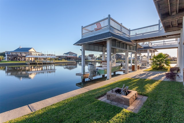 1295 Lagoon Dr, Crystal Beach, TX 77650 - dock area featuring boat lift, a fire pit, a lawn, and a water view