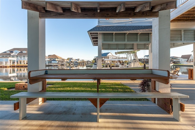 view of patio featuring a water view and a boat dock