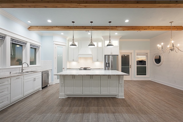 kitchen featuring white cabinetry, dark wood-type flooring, appliances with stainless steel finishes, decorative light fixtures, and sink