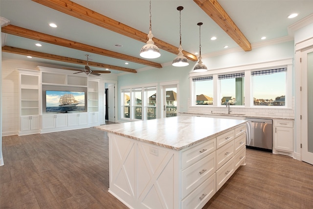 kitchen with stainless steel dishwasher, a center island, crown molding, and dark hardwood / wood-style floors