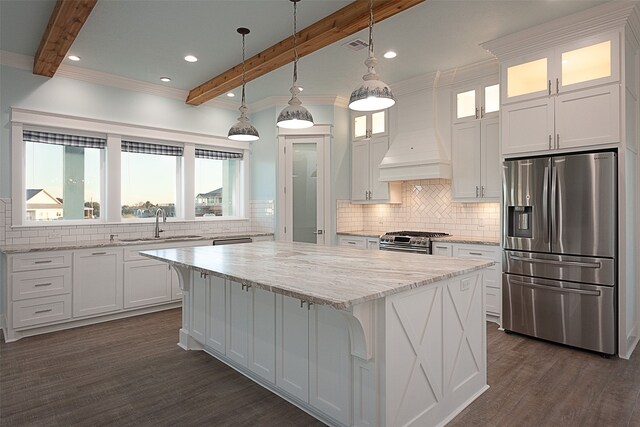 1295 Lagoon Dr, Crystal Beach, TX 77650 - kitchen with appliances with stainless steel finishes, custom exhaust hood, beamed ceiling, a center island, and white cabinetry