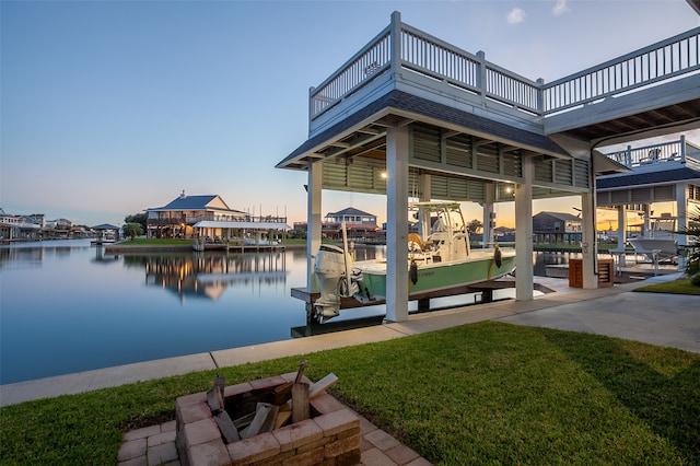 dock area featuring a water view and a lawn