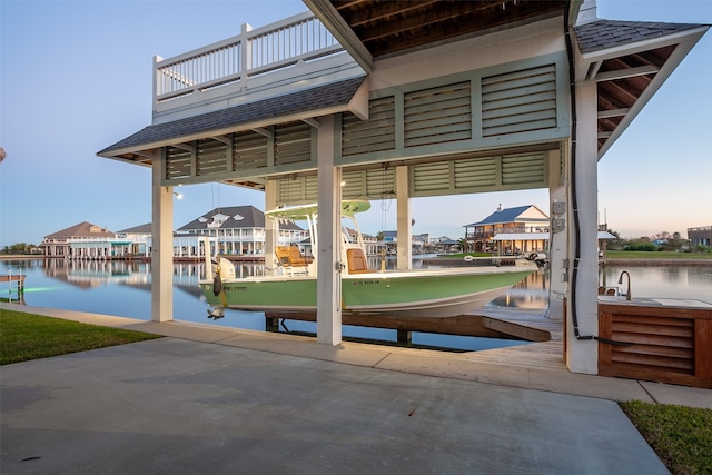 1295 Lagoon Dr, Crystal Beach, TX 77650 - view of patio / terrace featuring boat lift, a water view, and a dock