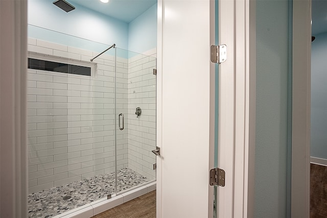 1295 Lagoon Dr, Crystal Beach, TX 77650 - bathroom featuring a stall shower and wood finished floors