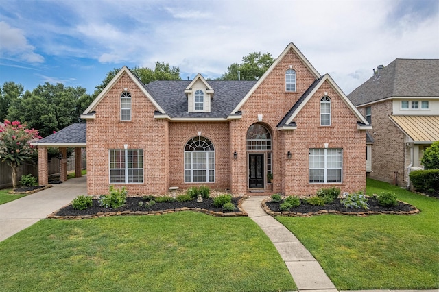 view of front of house with a front lawn and a carport