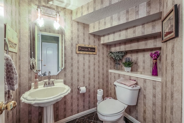 bathroom featuring tile patterned floors, sink, and toilet