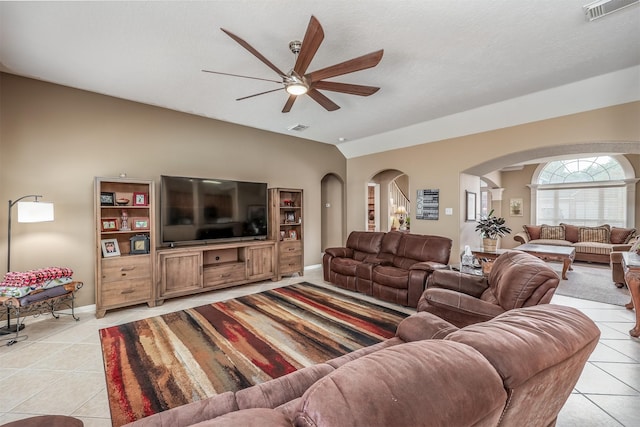 living room featuring vaulted ceiling, ceiling fan, and light tile patterned flooring